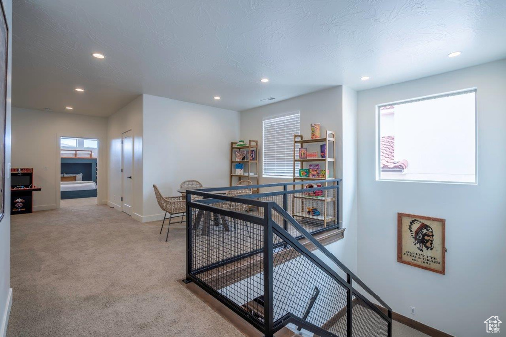 Hallway with an upstairs landing, baseboards, recessed lighting, and carpet flooring