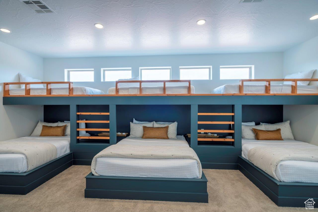 Bedroom featuring multiple windows, recessed lighting, and carpet