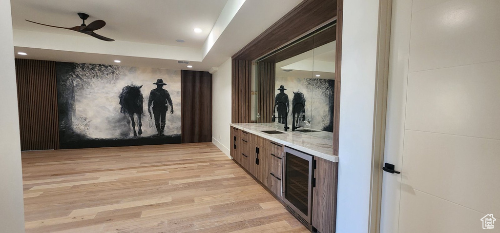 Community bar area featuring beverage cooler, ceiling fan, light wood finished floors, recessed lighting, and baseboards
