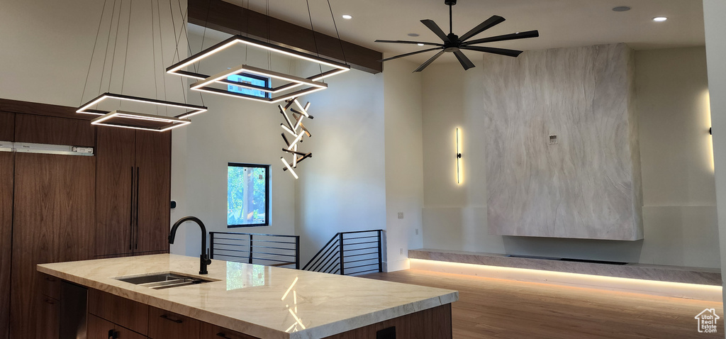Kitchen featuring a sink, modern cabinets, recessed lighting, ceiling fan, and open floor plan