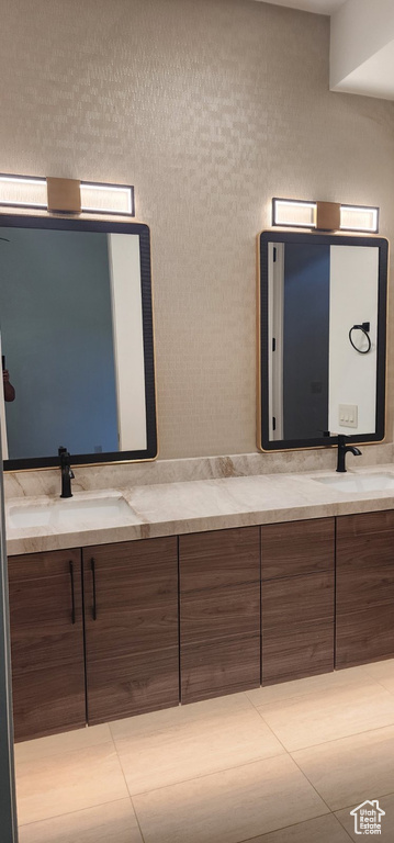 Bathroom with double vanity and tile patterned floors