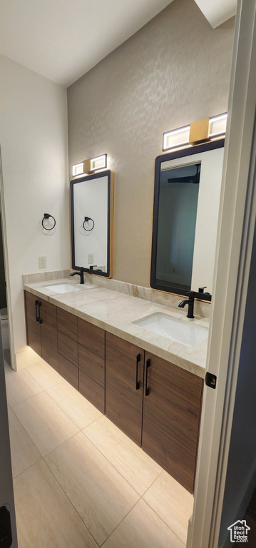 Bathroom featuring double vanity and tile patterned flooring