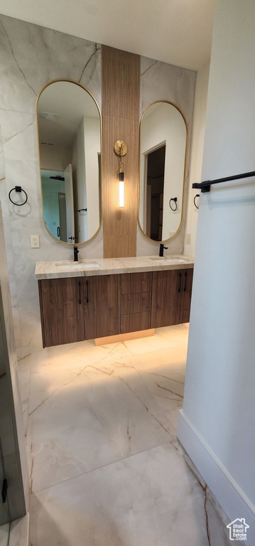 Bathroom with marble look tiles and double vanity