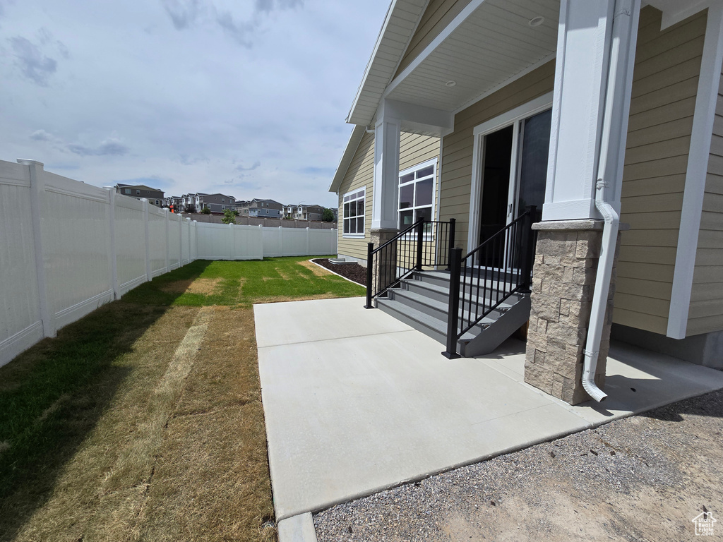 View of patio with entry steps and a residential view
