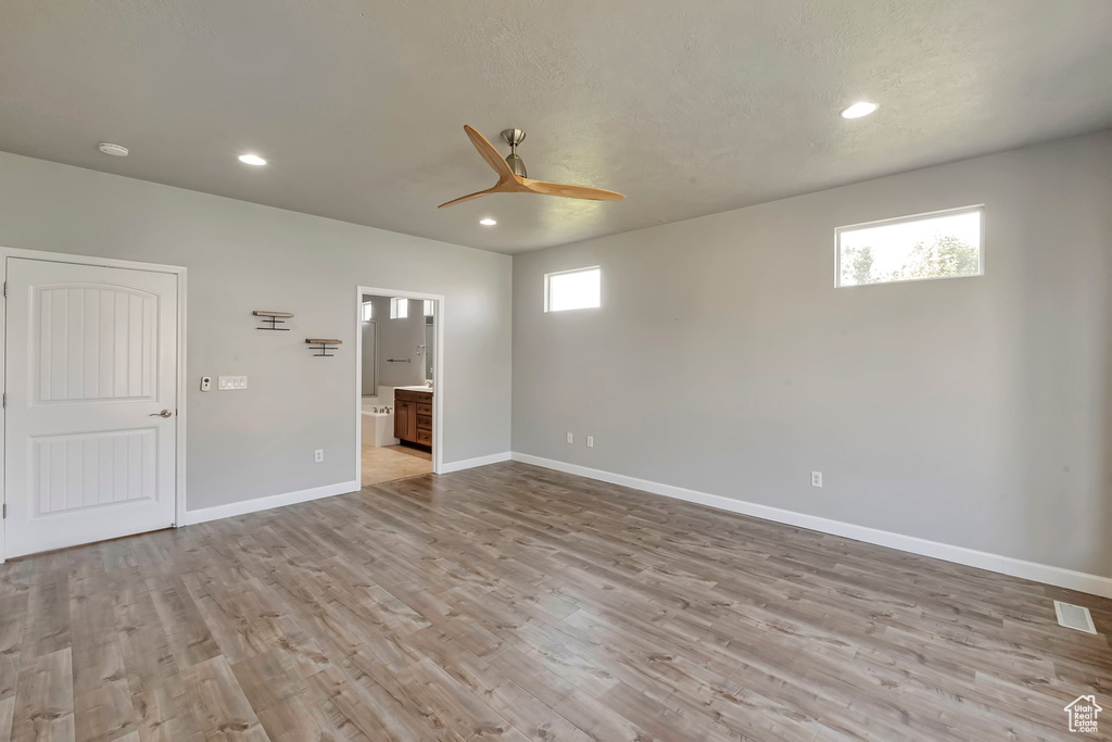 Spare room featuring a ceiling fan, light wood-type flooring, baseboards, and recessed lighting