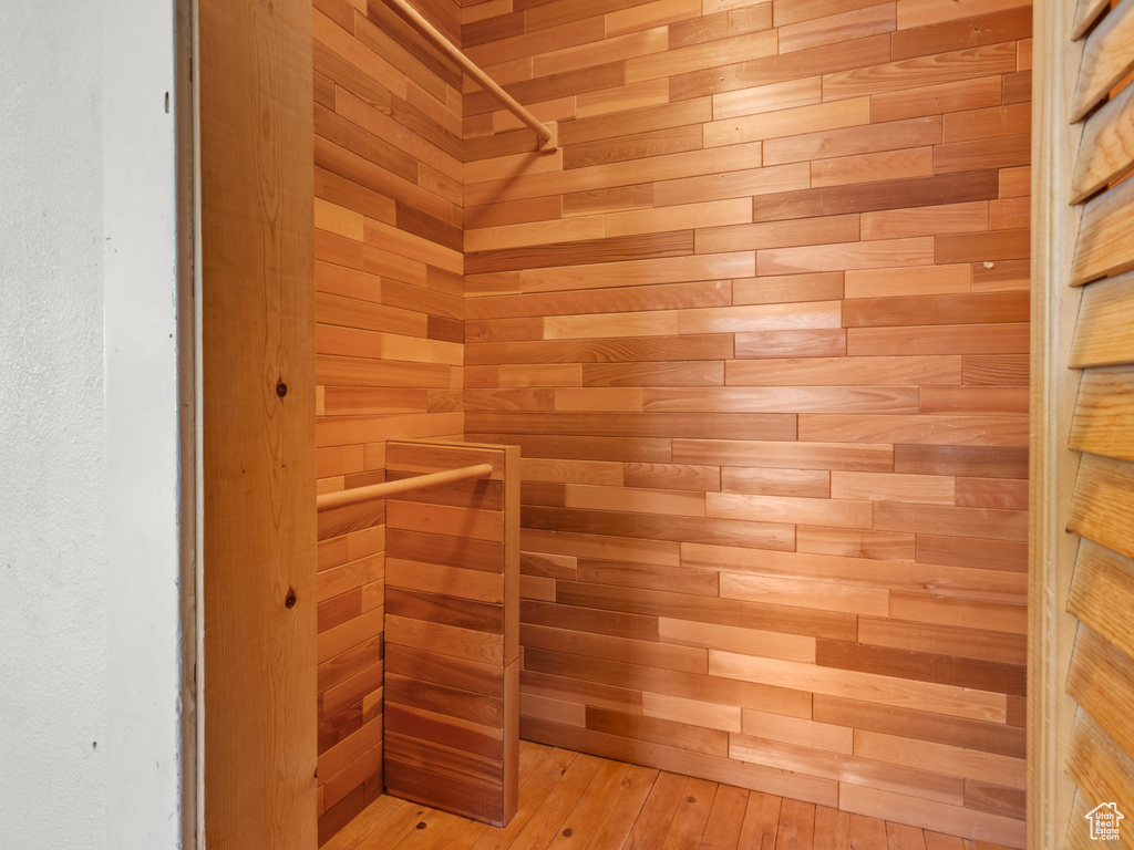Spacious closet with hardwood / wood-style flooring