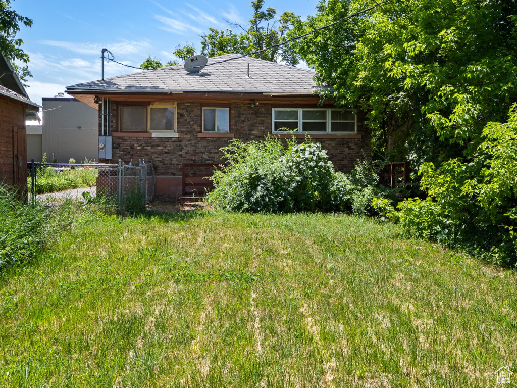 Back of house featuring brick siding