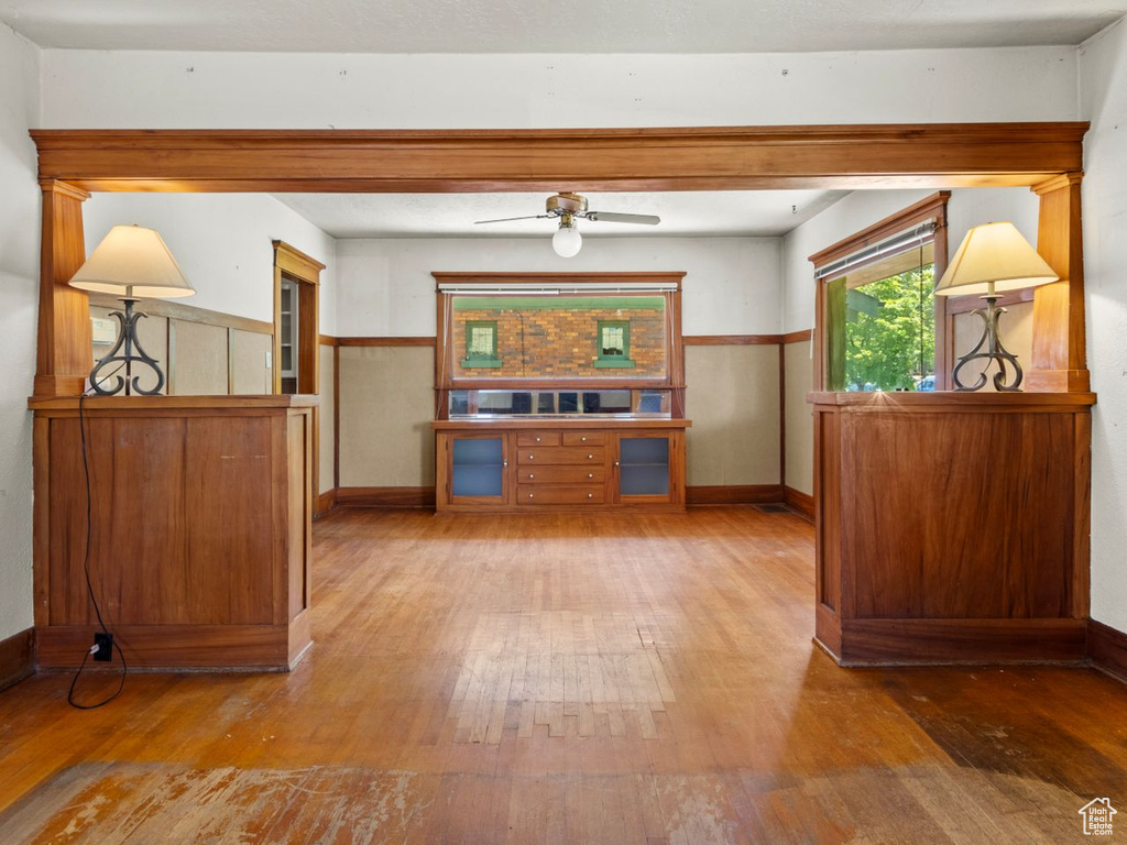 Dining space with hardwood / wood-style flooring, baseboards, and a ceiling fan