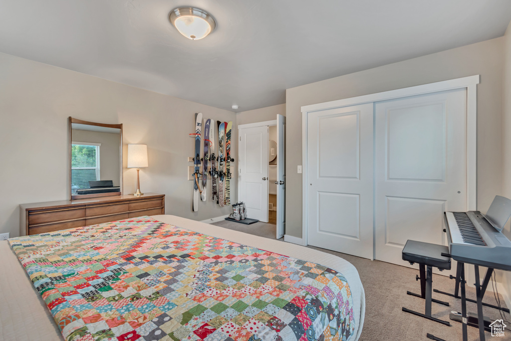 Carpeted bedroom featuring a closet
