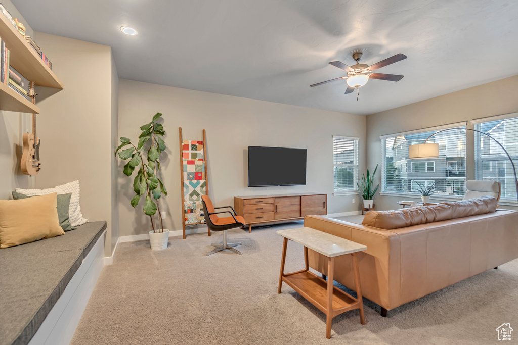 Living room featuring light carpet, a ceiling fan, baseboards, and recessed lighting