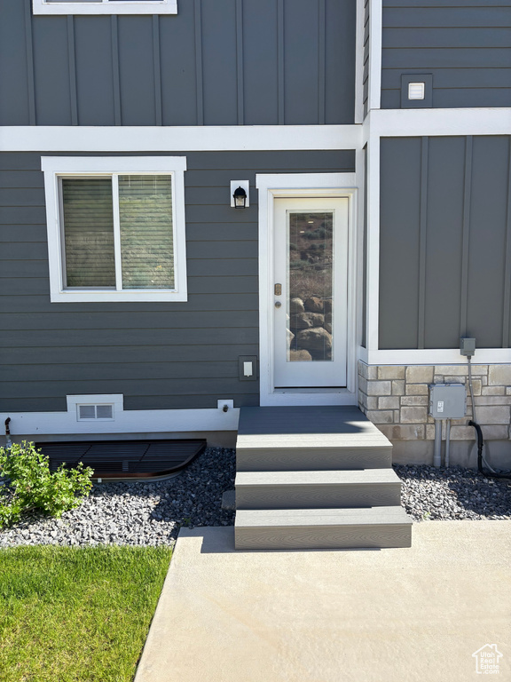 Entrance to property featuring board and batten siding