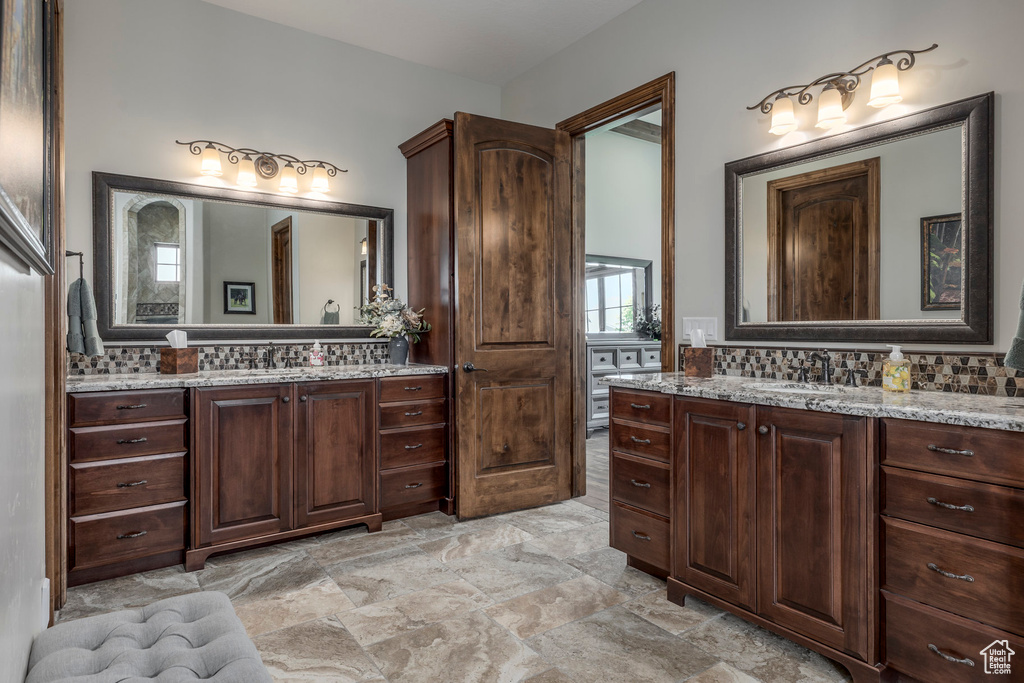 Full bathroom with two vanities and backsplash