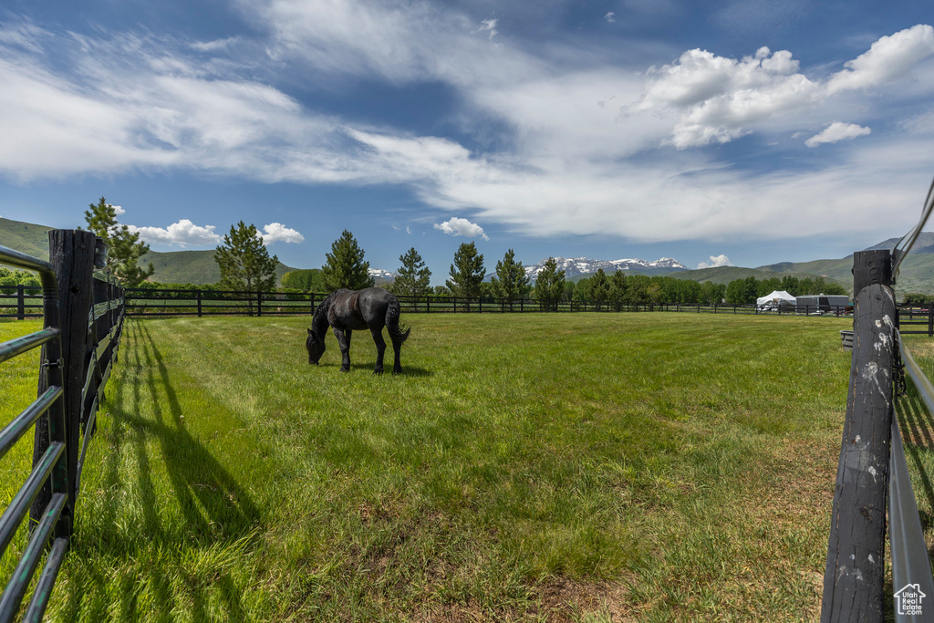 View of yard with a view of countryside, a mountain view, and an outdoor riding arena