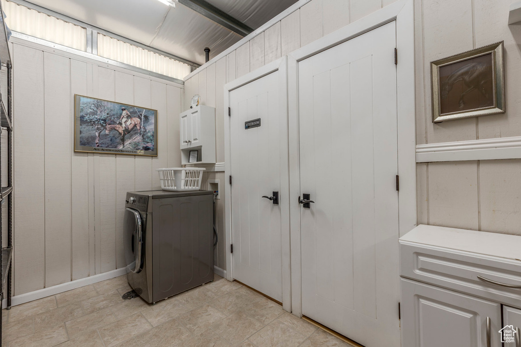 Laundry area featuring cabinet space and washer / dryer