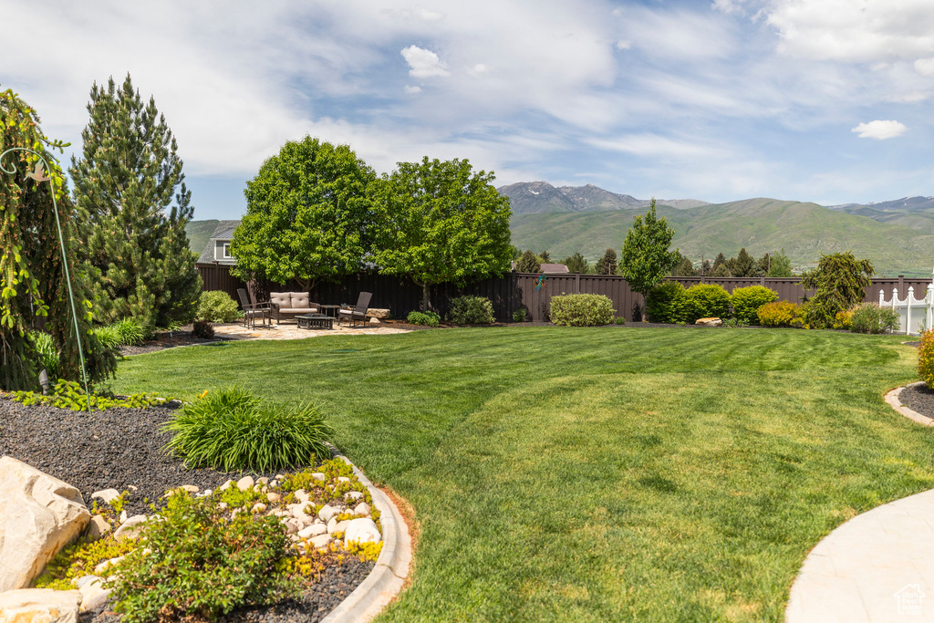 View of yard featuring a patio area, a mountain view, and an outdoor fire pit