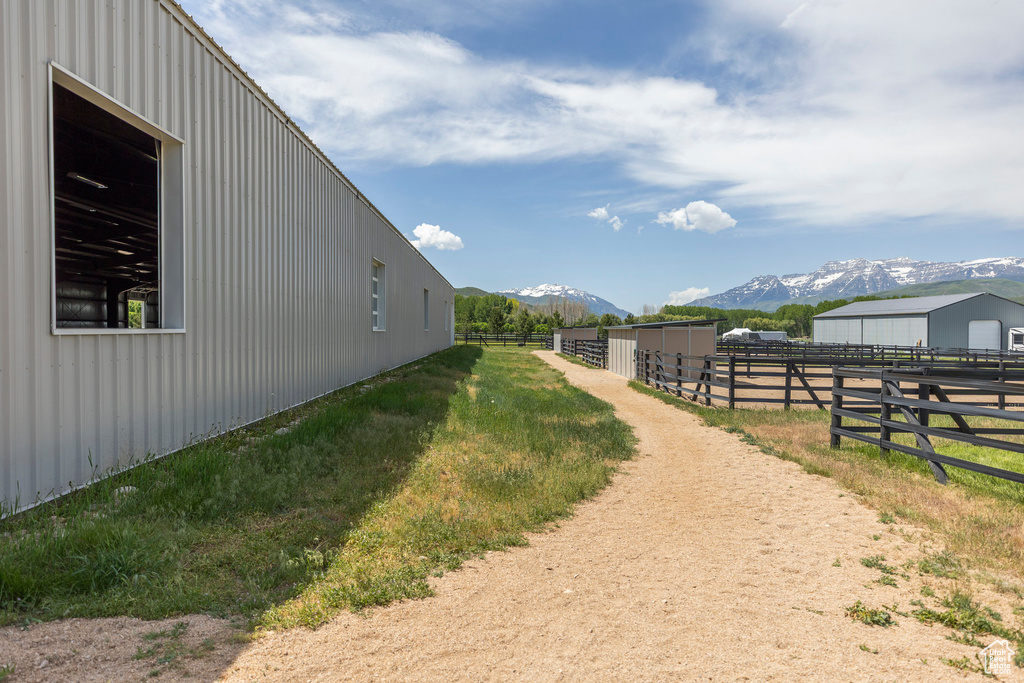View of yard featuring a mountain view, an exterior structure, and an outbuilding