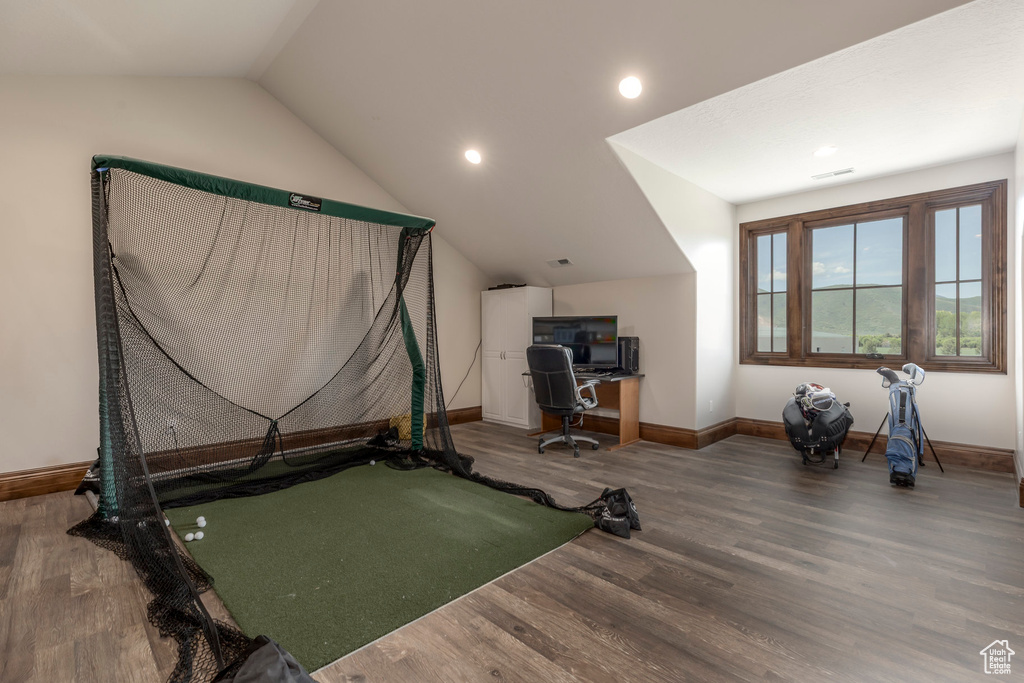Workout room featuring baseboards, wood finished floors, lofted ceiling, and recessed lighting