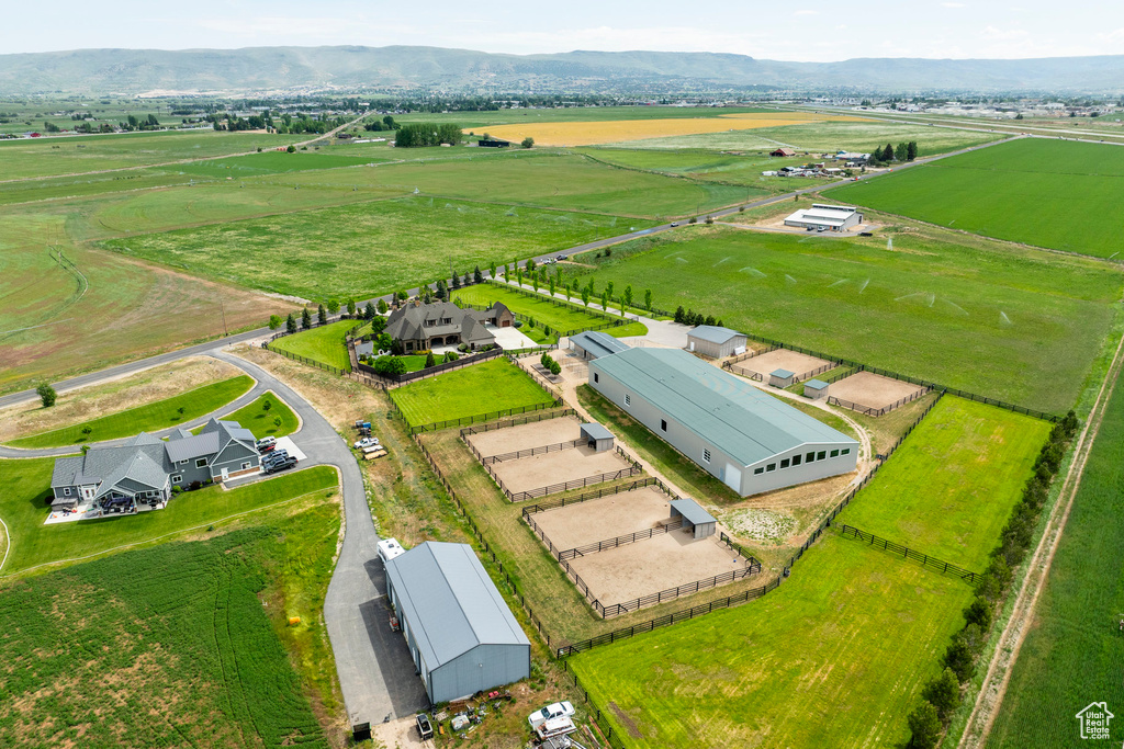 Overview of rural landscape featuring extensive farmland and a mountain backdrop