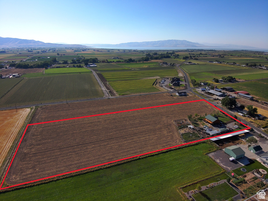 View of rural area with rows of crops, mountains, and property boundaries highlighted