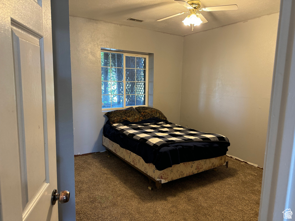 Bedroom featuring carpet and ceiling fan