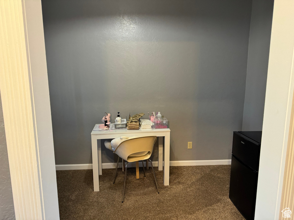 Carpeted home office with baseboards