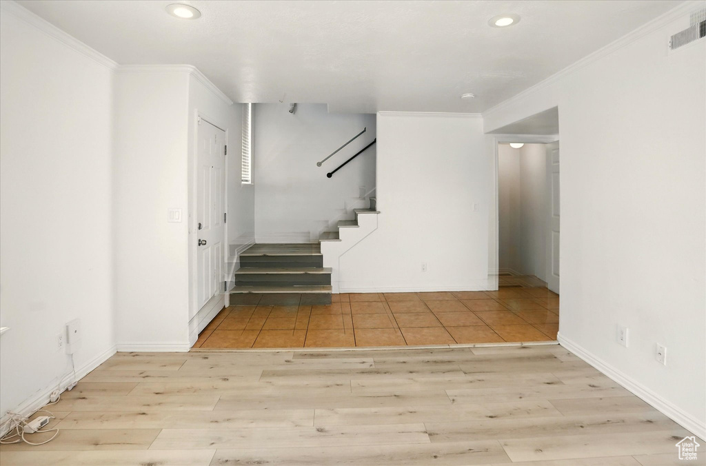 Staircase featuring ornamental molding, wood finished floors, recessed lighting, and baseboards