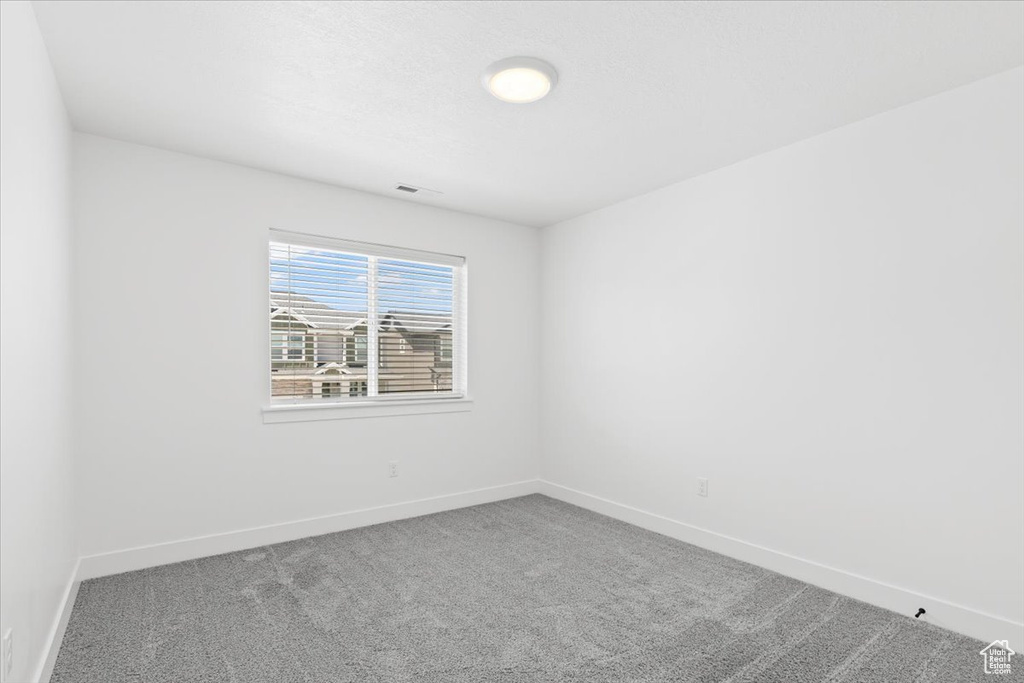 Unfurnished room with carpet flooring and baseboards