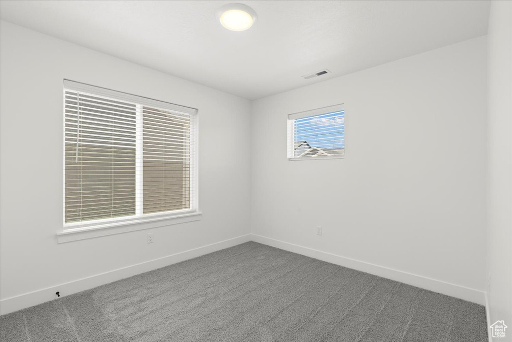 Unfurnished room with carpet flooring and baseboards