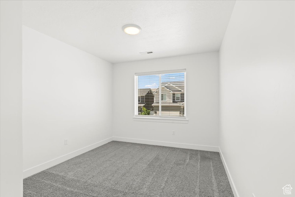 Empty room with baseboards and carpet flooring