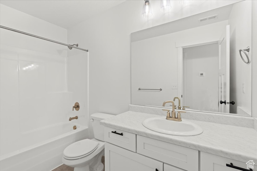Full bathroom featuring vanity, toilet, and washtub / shower combination