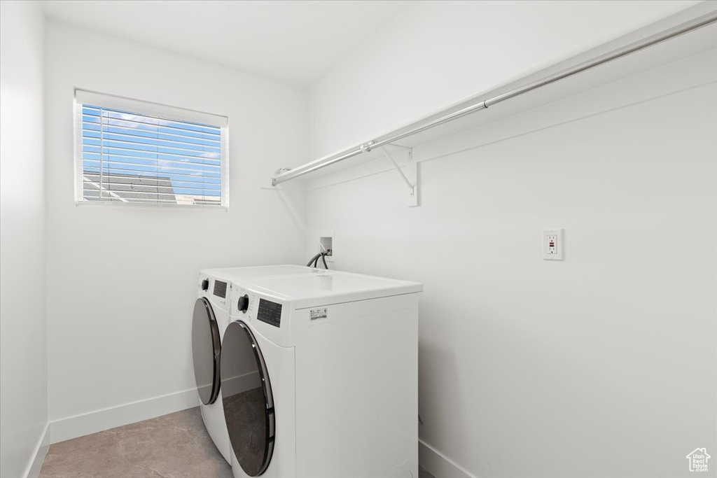 Laundry room with washing machine and dryer and baseboards
