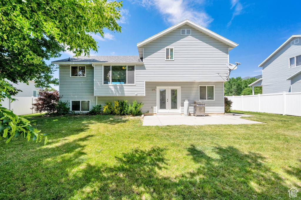 Rear view of property with french doors and a patio area