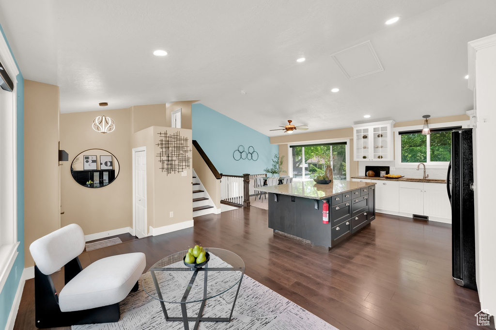 Living room with ceiling fan, stairs, dark wood-style floors, baseboards, and recessed lighting