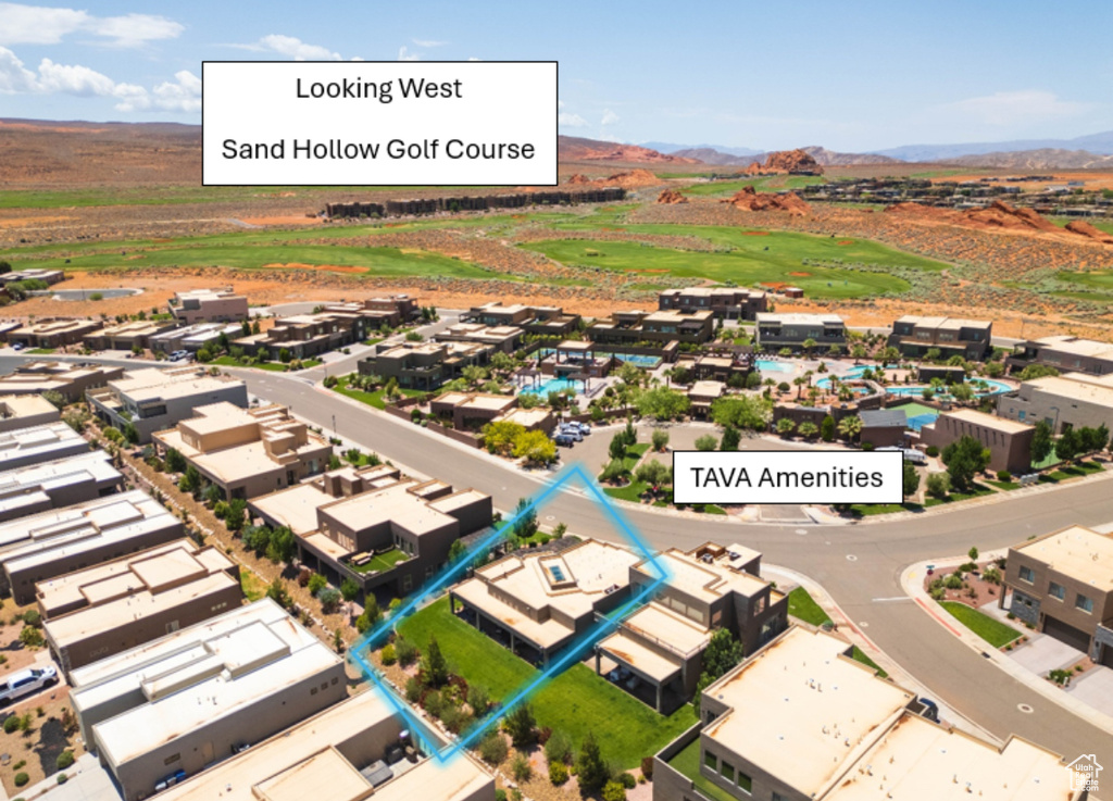 Aerial view of property and surrounding area with a mountainous background and property boundaries highlighted