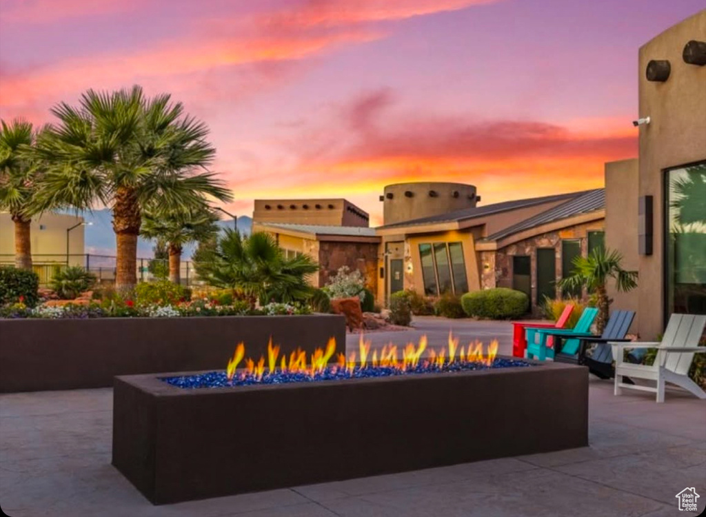Patio terrace at dusk featuring a fire pit and a patio area