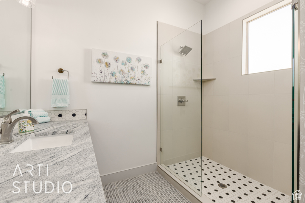 Bathroom featuring walk in shower and vanity