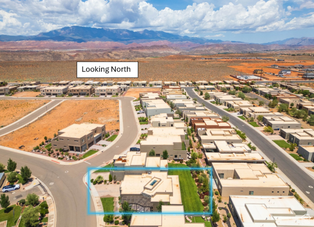 Aerial perspective of suburban area featuring a mountain backdrop and property boundaries highlighted
