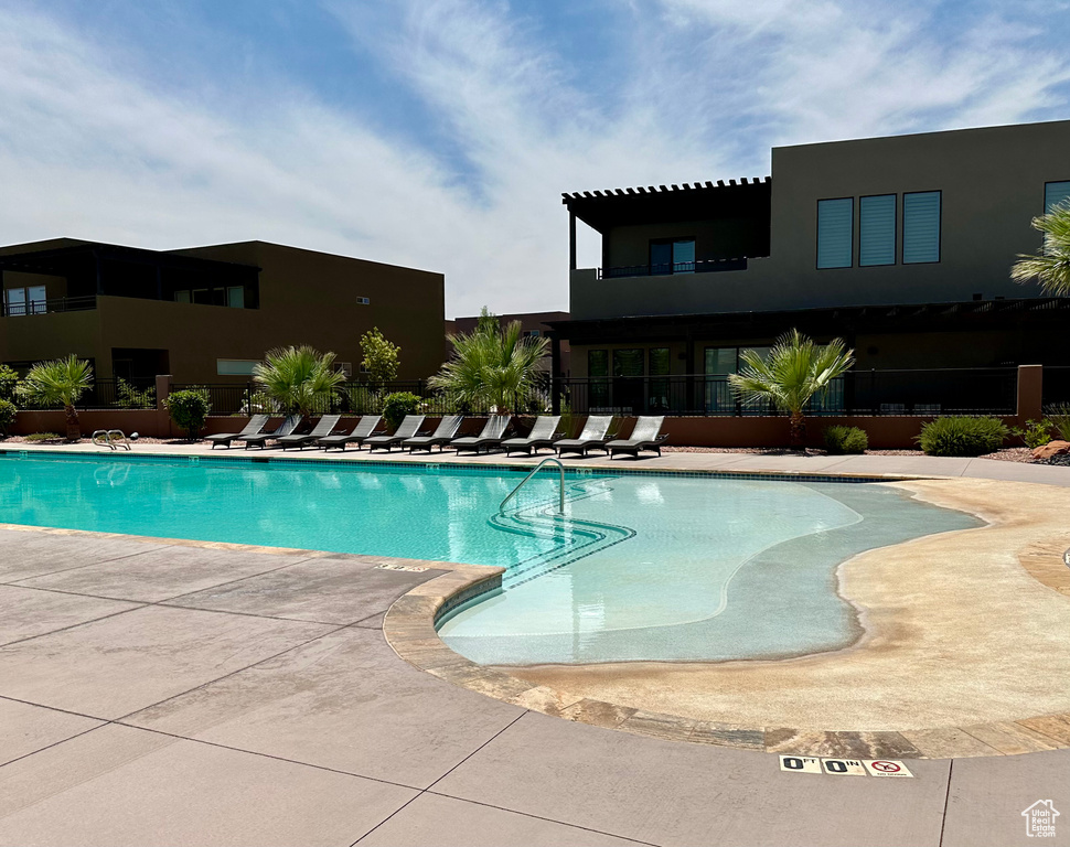 Community pool with a patio