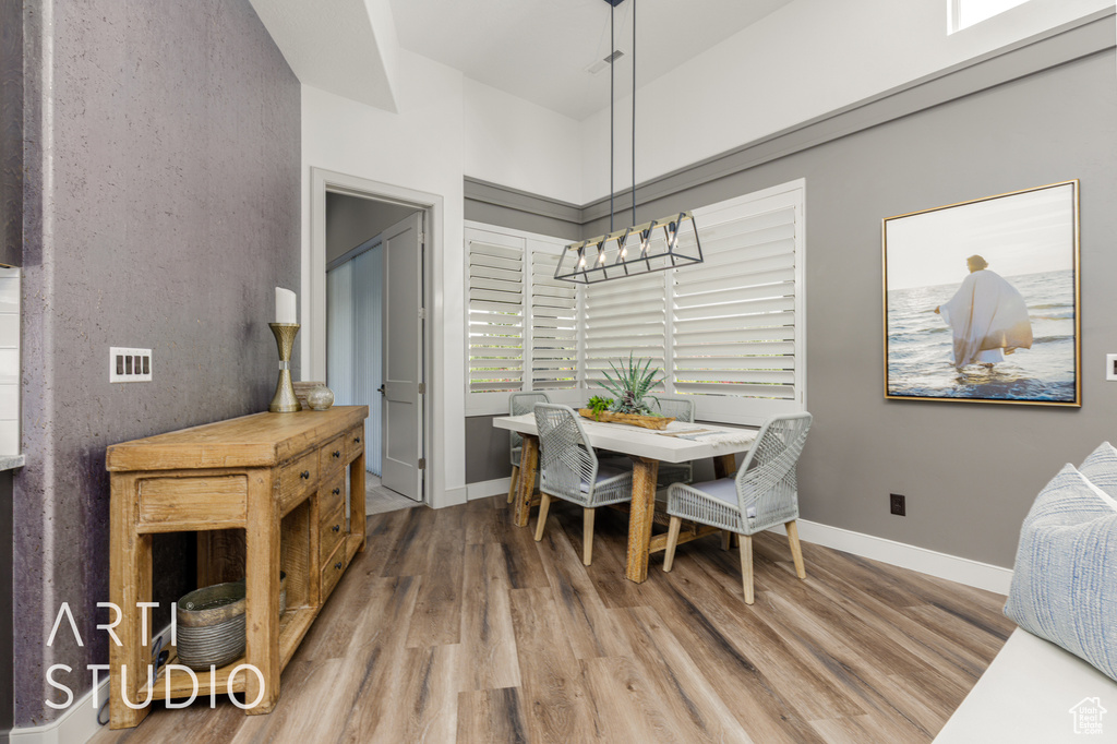 Dining room featuring wood finished floors and baseboards