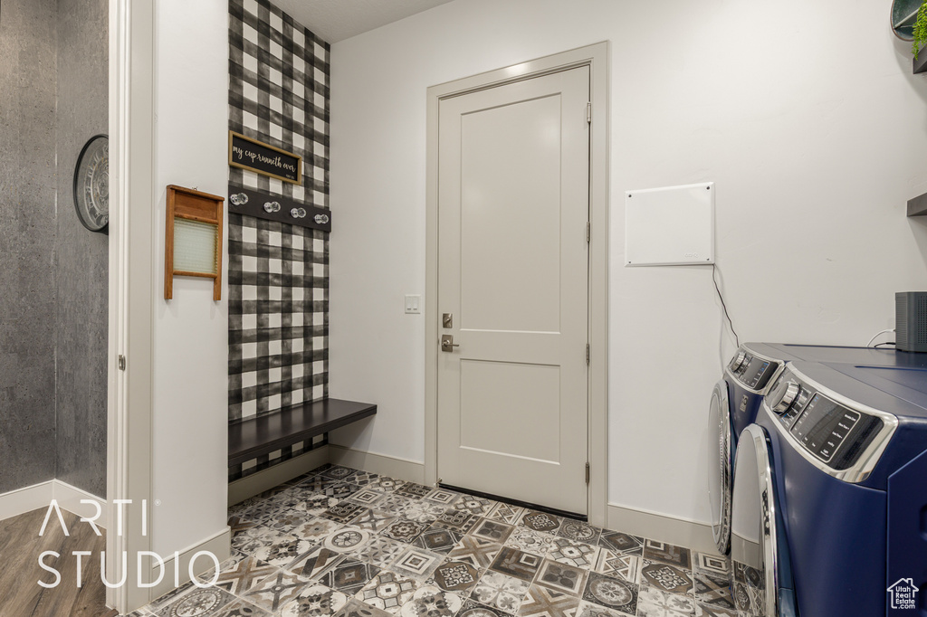 Washroom featuring separate washer and dryer and baseboards
