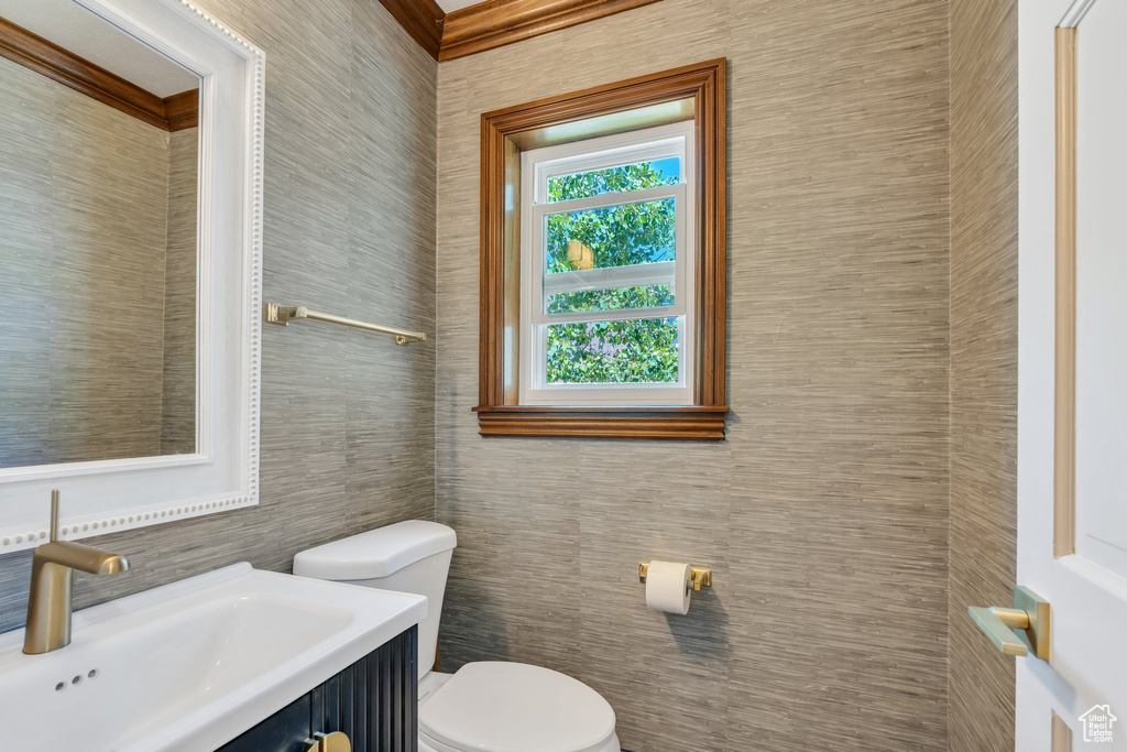 Bathroom with tile walls, toilet, and vanity