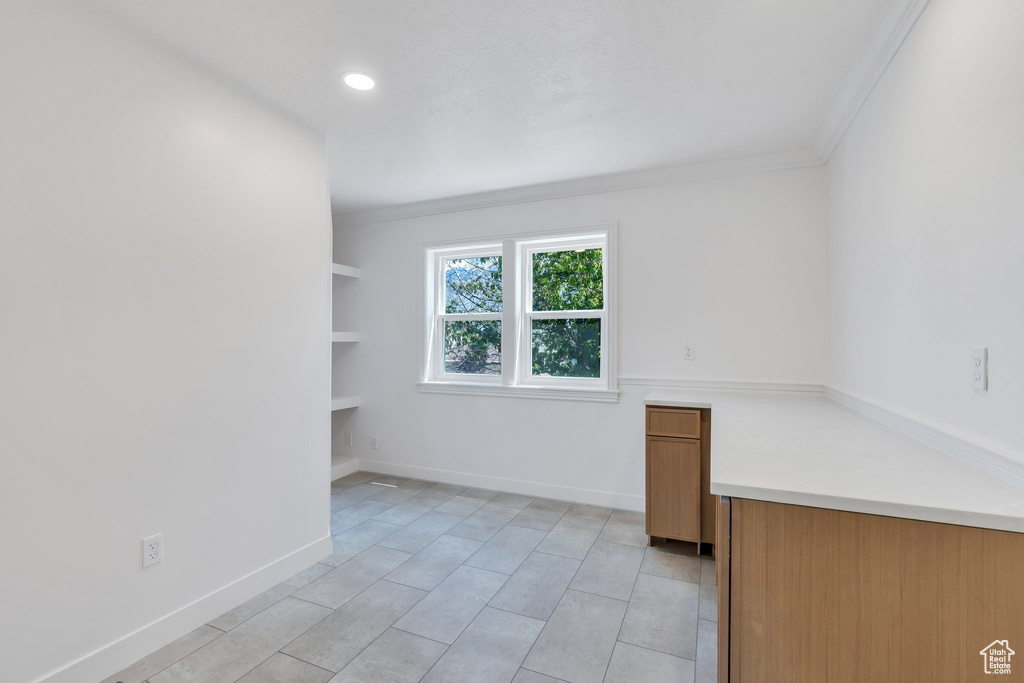 Empty room with ornamental molding, light tile patterned flooring, recessed lighting, and baseboards