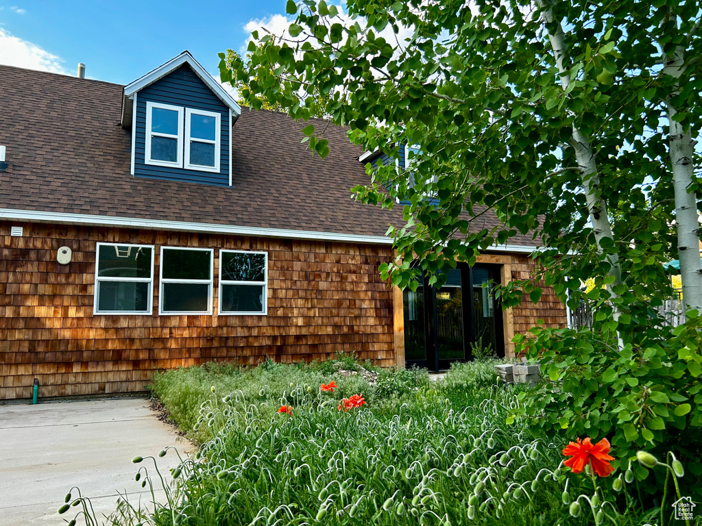 View of front of home with a shingled roof