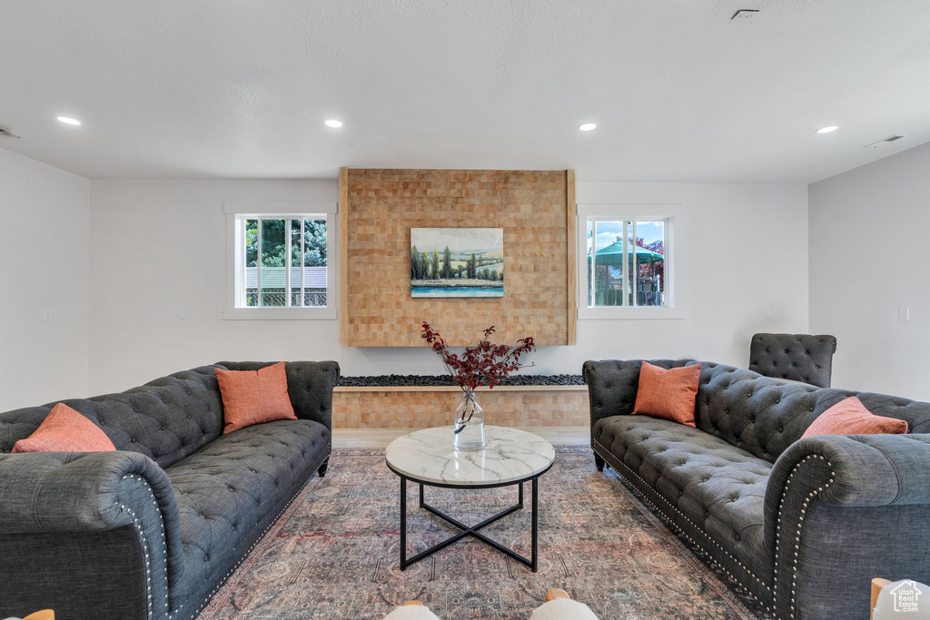 Living area with healthy amount of natural light, recessed lighting, and wood finished floors