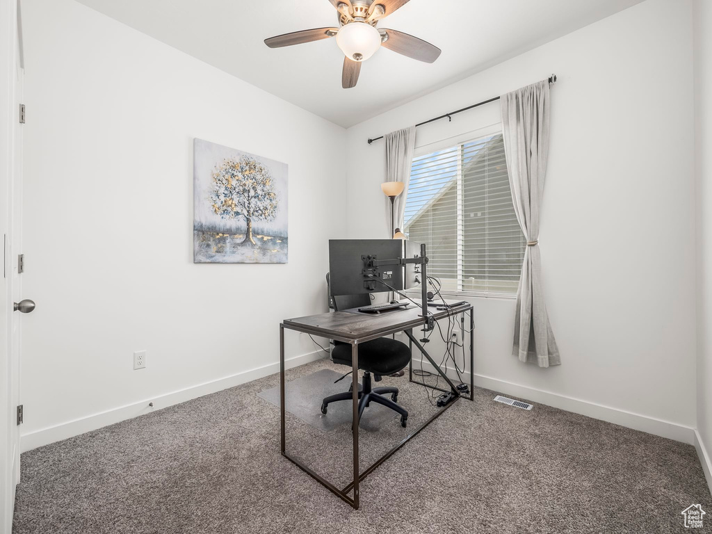 Home office featuring baseboards, carpet, and ceiling fan