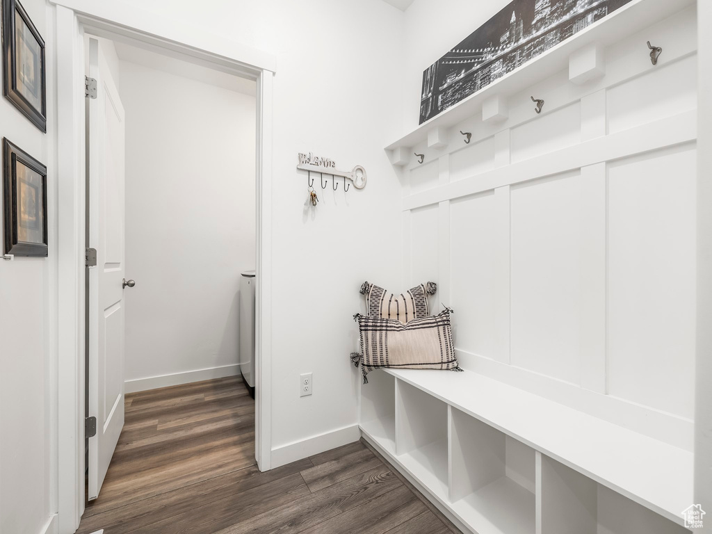 Mudroom featuring dark wood-type flooring and baseboards