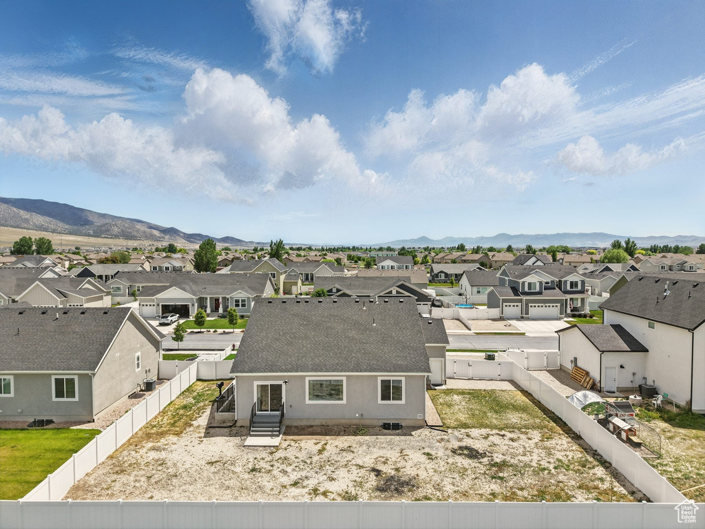 Aerial view of residential area featuring a mountainous background