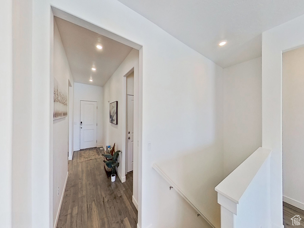 Hallway featuring an upstairs landing, wood finished floors, recessed lighting, and baseboards