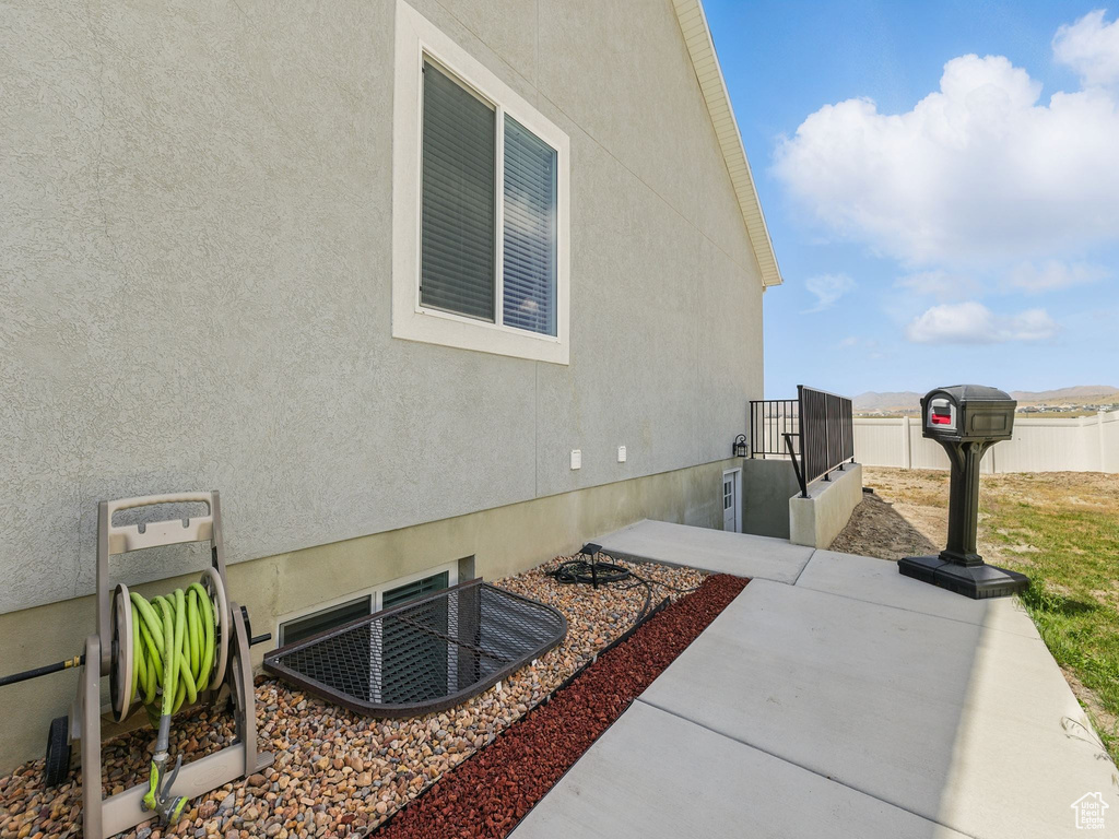 View of home\'s exterior with stucco siding and a patio area
