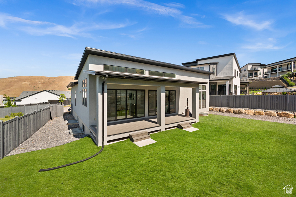 Rear view of house featuring stucco siding